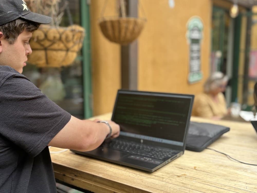A support engineer working through an issue live on a laptop